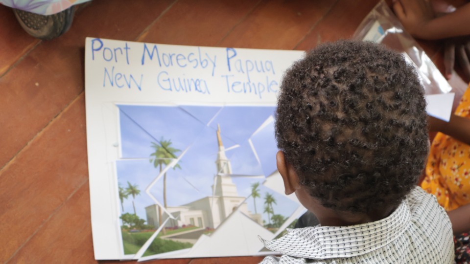 A child in the Sabusa Branch works to complete a puzzle revealing the Port Moresby Papua New Guinea Temple. 
